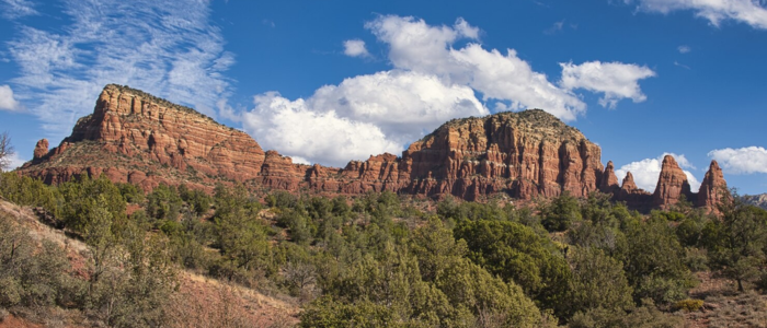 Red rock formations under a clear blue sky showcase the area's unique geological beauty.