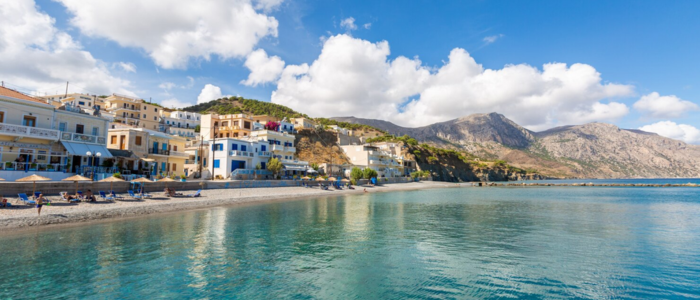 Crete coastal village with beach, sea, and mountains